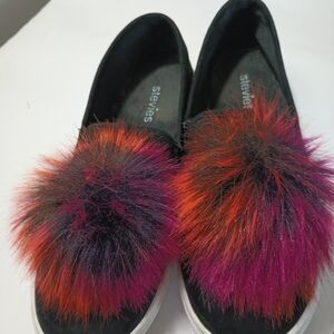 Stevies Black Slip-Ons with Vibrant Pom Poms